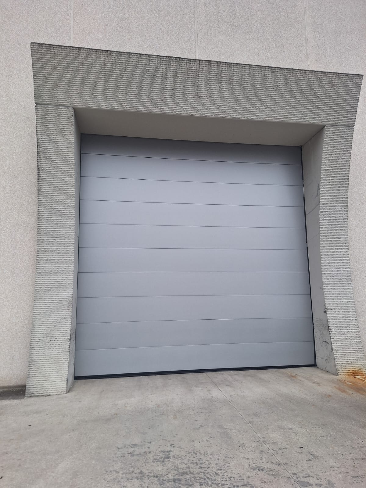 portone sezionale industriale a <p>porta sezionale oltre luce, con pannello con doga da 25cm. RAL 9006</p>